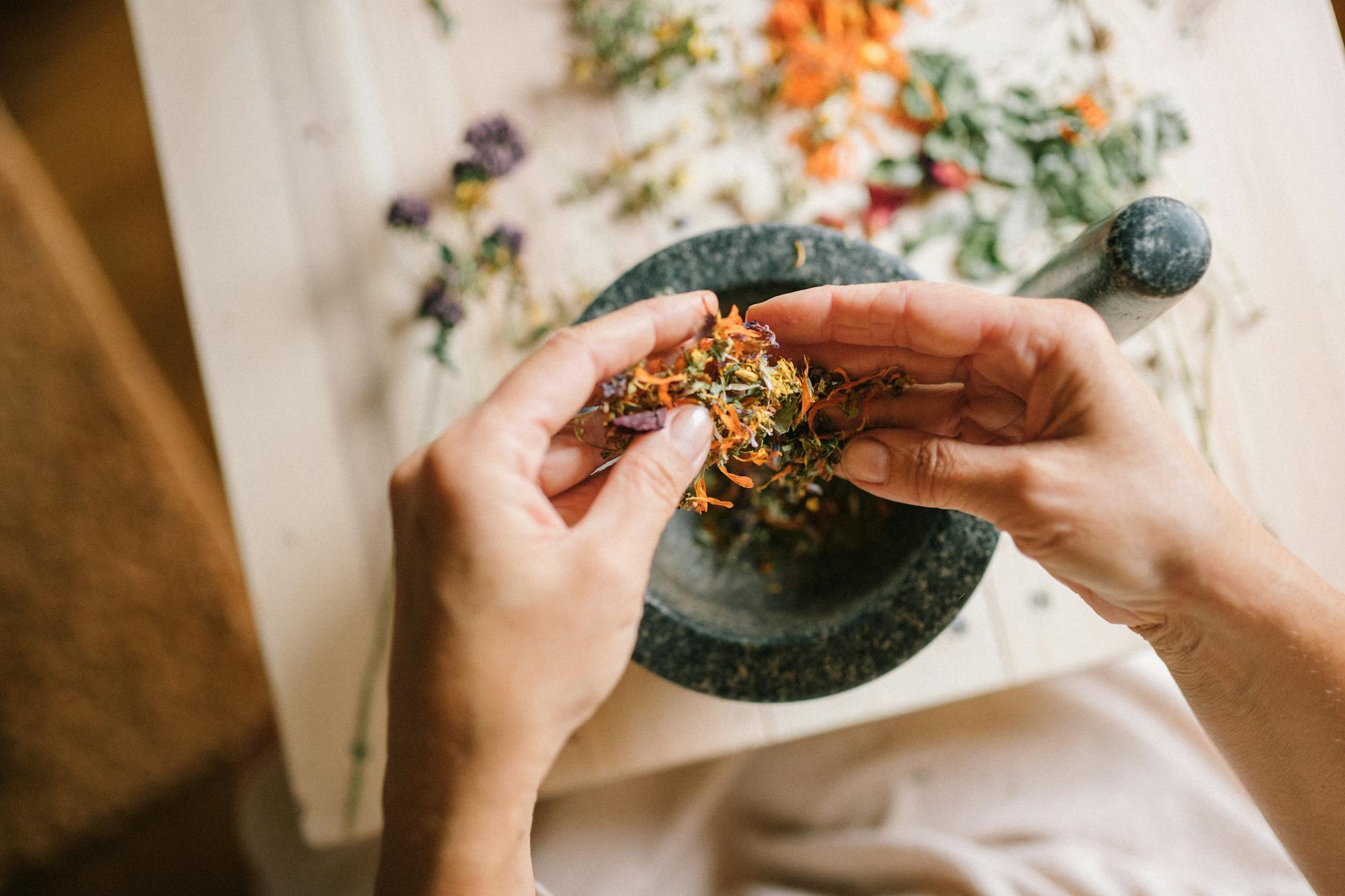 close up of woman mixing herbs and spices